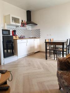 a living room with a kitchen and a table at Mareva House - Discreet with parking in Gignac-la-Nerthe