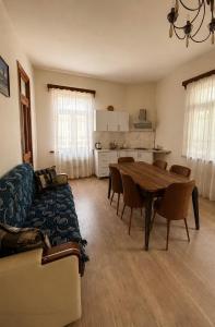 a living room with a table and a couch at Guesthouse Tornike in Gonio +14 photos