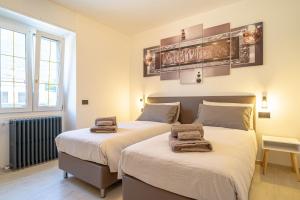 a bedroom with two beds with towels on them at Spinedi Royale in Postalesio +83 photos