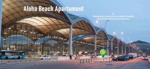 a large building with cars parked in front of it at Aloha Beach Apartament Con Baño privado in Alicante