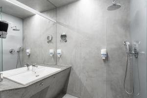 a bathroom with a sink and a shower at Aparthotel Blend City Center in Bucharest +42 photos