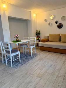 a living room with a table and chairs and a couch at Apartmani Klarić in Zadar +37 photos