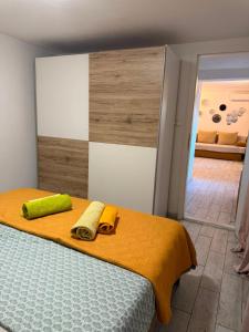 a bedroom with a bed with two towels on it at Apartmani Klarić in Zadar