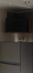 a refrigerator with a flat screen tv on top of it at camping des iscles 167 in La Roque-dʼAnthéron