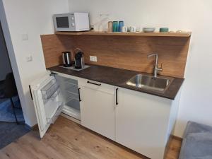 a small kitchen with a sink and a microwave at chalet10 in Samnaun