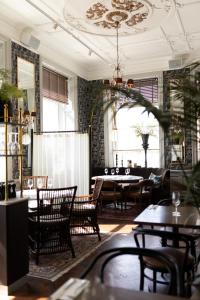 a restaurant with tables and chairs in a room at Continental du Sud in Ystad