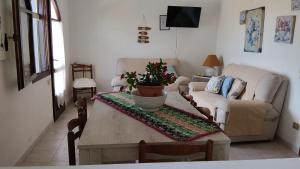 a living room with a table and a couch at Soberania in Pula