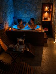 a man and woman sitting in a bath tub at SPA ROOM SICILIA - Suite con Spa ad uso esclusivo Jacuzzi Sauna Hammam in Rosolini