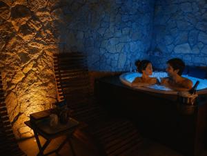 a man and a woman in a bath tub at SPA ROOM SICILIA - Suite con Spa ad uso esclusivo Jacuzzi Sauna Hammam in Rosolini