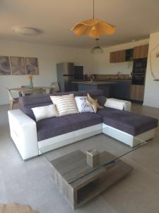 a living room with a couch and a table at Les embruns du retz in Chaumes en Retz +8 photos