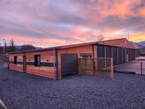 a brick building with a garage with a goal at La Palissandre in Tallard