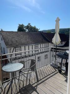 a patio with a table and chairs on a deck at Alte Wollspinnerei Melsungen in Melsungen