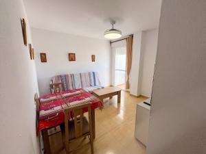 a living room with a table and a couch at Spacious Apartment in Barbate - Terrace with Sea View in Barbate