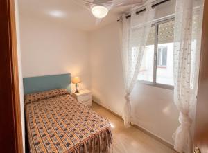a bedroom with a bed and a window at Spacious Apartment in Barbate - Terrace with Sea View in Barbate