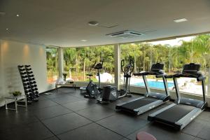 a gym with cardio equipment and a large window at Falls Iguazú Hotel in Puerto Iguazú