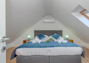 a bedroom with a large bed with blue and white pillows at Iron Gates Apartments in Split +51 photos