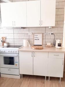 a kitchen with white cabinets and a counter top at Comfortable Studio in Santiago do Cacém, private pool, 65 m² in Santiago do Cacém