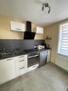 a kitchen with a sink and a stove top oven at Alte Wollspinnerei Melsungen in Melsungen +7 photos