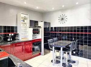 a kitchen with a table and black and white tiles at Maison confortable à Ver-sur-Mer avec jardin privé in Ver-sur-Mer