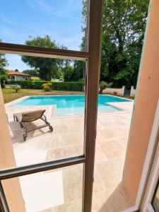 a view from a window of a swimming pool at Villa de charme à Ribérac avec piscine privée in Ribérac