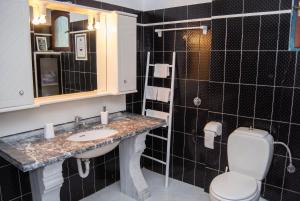 a bathroom with a sink and a toilet at Picturesque Villa in Limnos + Enclosed Garden + Sea View in Lemnos