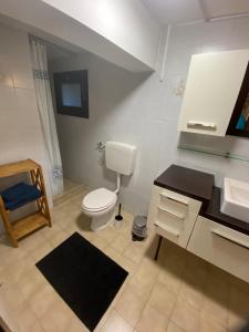 a bathroom with a toilet and a sink at Atelier Suvereto in Suvereto +22 photos