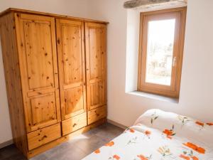 a bedroom with a wooden cabinet and a bed at Appartement cosy à Bonifacio avec vue sur la mer - 45 m² in Bonifacio +14 photos