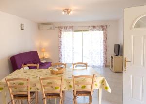a dining room and living room with a table and chairs at Maison confortable avec vue sur la mer et la montagne à Oletta. in Oletta +15 photos