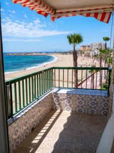 a balcony with a view of the beach at Apartment with pool in Águilas 75 m² with sea view in Águilas