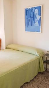 a bed in a room with a painting on the wall at Apartment with pool in Águilas 75 m² with sea view in Águilas +4 photos