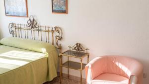 a room with a bed and a chair and a table at Apartment with pool in Águilas 75 m² with sea view in Águilas