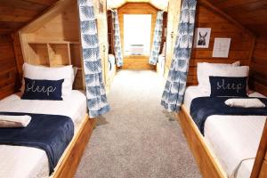 a room with two beds in a cabin at Charming Oasis - Ultimate Rustic Getaway! in St. Augustine