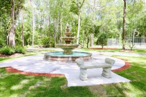 a fountain with a bench in a park at Charming Oasis - Ultimate Rustic Getaway! in St. Augustine +24 photos