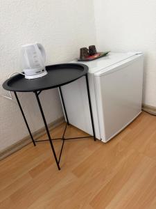 a black table next to a white refrigerator at Apartment Amila in Jajce