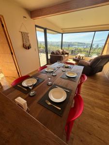 a dining room table with wine glasses on top of it at Cabañas Vista Volcanes del Sur in Llanquihue +114 photos