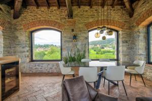 a dining room with a table and chairs and windows at Relais & Spa Castello di Casiglio in Erba