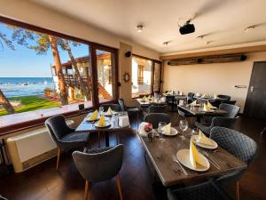 a restaurant with tables and chairs and a large window at Royal Mediterran in Siófok