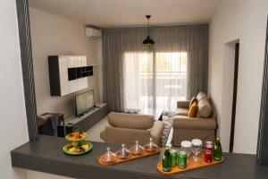 a living room with a couch and a mirror at AB Business Hôtel in Nouakchott