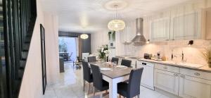 a kitchen with a table and chairs and a dining room at LE BAYARD Authentique Maison Sétoise Patio Climatisée Centre Historique Parking payant à proximité in Sète