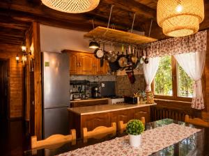 a kitchen with a stainless steel refrigerator and a table at Old Mark's House Sinaia in Sinaia