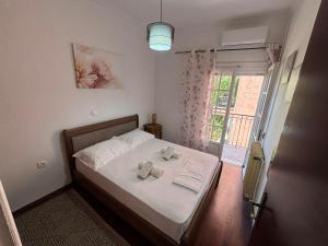 a bedroom with a bed with two teddy bears on it at Chrysa's apartment in Anemómylos
