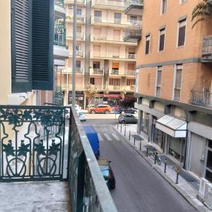a car parked on a street in a city with buildings at Piazza Verdi Liberty House in Lecce