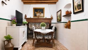 a dining room with a table and a fireplace at Casa de la Abuela - Encanto rural para grupos in Campofrío