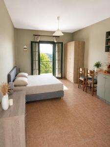 a bedroom with a bed and a table and chairs at Anastasis Apartments in Trapezaki