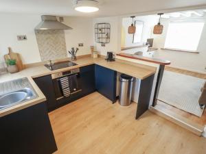 a kitchen with a sink and a counter top at Pax Cottage in Beccles