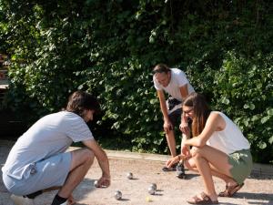 a group of people playing with balls on the sidewalk at Camping Léman Plage in Excénevex