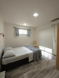 a bedroom with a bed and a window in a room at Casa con jardín Las Marías 1 in Miramar