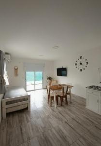 a living room with a table and a dining room at Casa con jardín Las Marías 1 in Miramar
