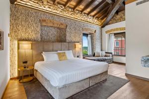 a bedroom with a large bed and a couch at Relais & Spa Castello di Casiglio in Erba +107 photos