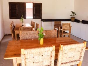 a dining room with wooden tables and chairs at Vila Riomar in Luis Correia +41 photos